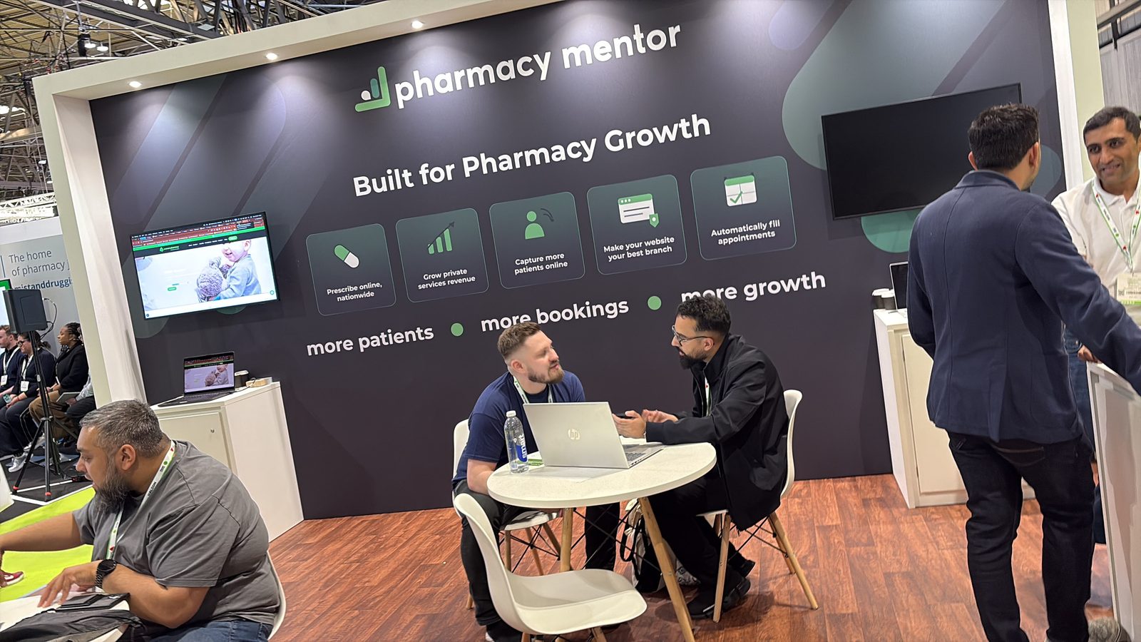 Pharmacy Mentor stand at The Pharmacy Show 2026 with visitors discussing pharmacy growth