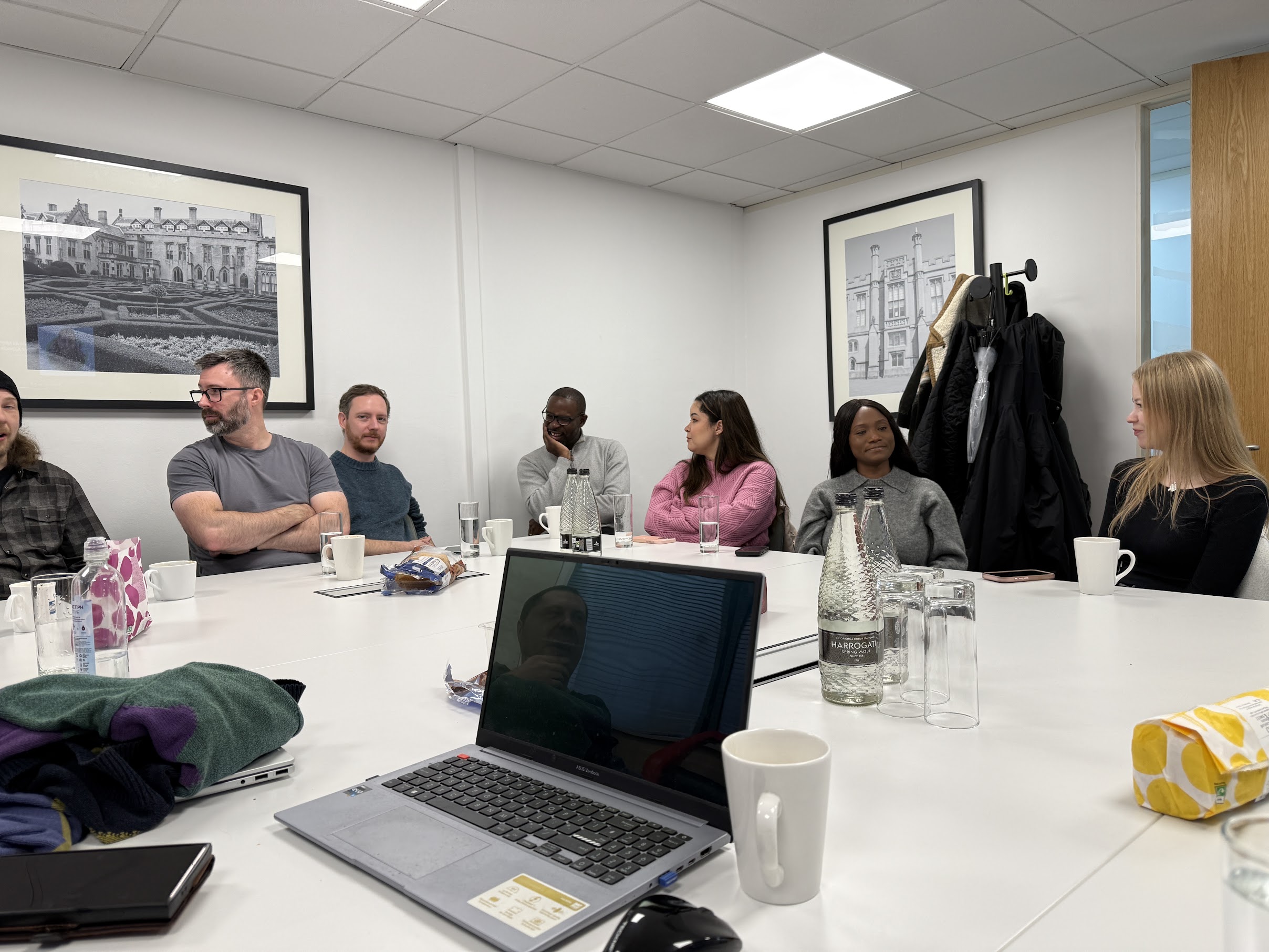 UK team members sharing ideas around a meeting table